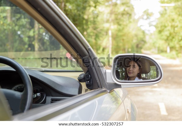 Lady with Car, person drive a car look out\
sideview mirror.\
\
