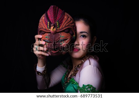 Lady covered by javanese mask