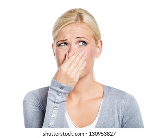 Lady covers nose with hand showing that something stinks, isolated on white