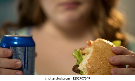 Lady Eating Junk Food And Drinking Sugary Soda From Can, Overeating Problem