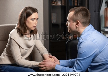 Lady employee in field of psychology supports and listens man mental problems. Male person in blue shirt tells about problems associated with work and fatigue