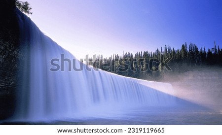 Lady Evelyn Falls in Northwest Canada. Awe-inspiring falls cascade over cliffs in Lady Evelyn Falls Territorial Park Popular spot for hiking, camping, fishing, and remote waterfall projects