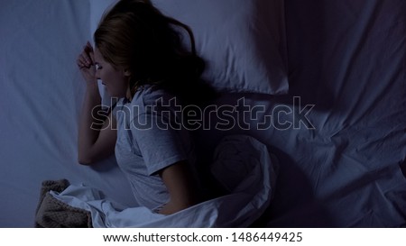 Lady feeling sharp stomachache during sleeping, suffering from cystitis illness