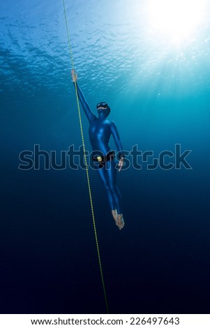 Similar – From below full body of unrecognizable active teen boy wearing yellow flippers snorkeling by coral reef in deep ocean with crystal clear waters at Menorca