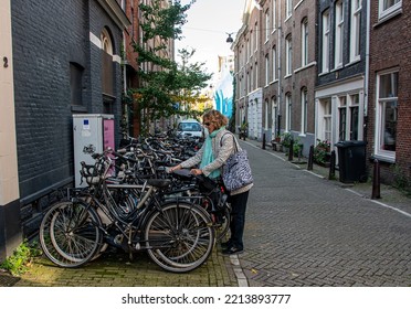 A Lady Gets Her Bicycle For The Morning Commute To Work - 12.10.2022 Amsterdam 