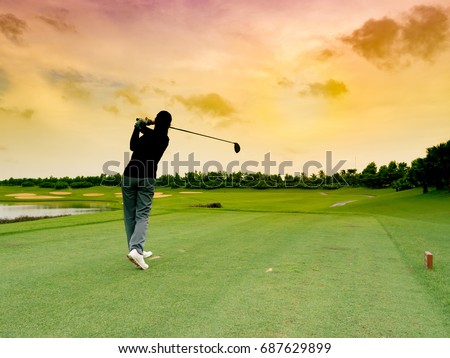 Lady golfer, girl golf player hit the golf ball with full swing, follow through on the tee at sunrise beautiful golf course