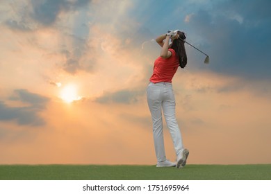 Lady golfer playing golf during beautiful sunset. - Powered by Shutterstock