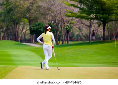 Lady Golfer Standing On The Green.