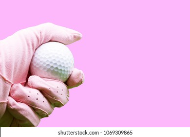 Lady Golfer Wears Pink Golf Glove Is Holding Golf Ball Isolated On Pink Background