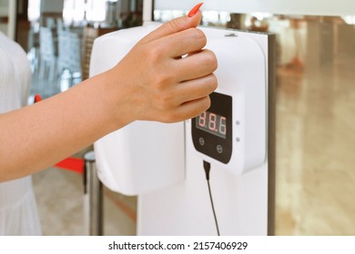 Lady Hand Checking Temperature Before Entering Restaurant With Automatic Body Measuring Temperature Check Machine