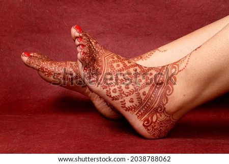 Lady Hand  Feet with Indian Heena In Indian wedding with Red Background | isolated beautiful feet and hand 
