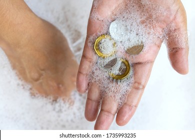 Lady Hands Cleaning Singapore Coins Money With Soap Foam To Prevent The Spread Of Bacteria And Viruses. Anti Corona Virus Covid-19 Ptotective Concept, New Normal Concept