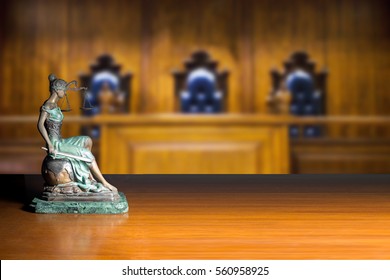 Lady Justice And Empty Bench With Judge Chairs In Courtroom