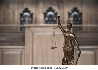 Lady Justice And Empty Bench With Judge Chairs In Courtroom