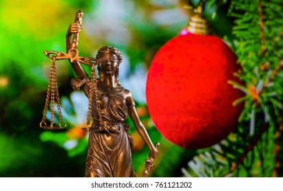 Lady Justice In Front Of A Christmas Tree