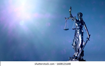 lady justice or justitia - blindfolded figurine holding balance scales - Panoamic image wih copy space.
