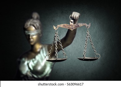 Lady Justice or Themis or Justilia (Goddess of justice) on emerald background - Shutterstock ID 563096617