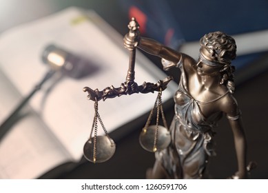 Lady Justice, Themis, Statue Of Justice On Books Background. Law Concept With Justice Figurine In Library