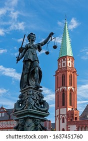 Lady Justice and the tower of the Nikolai church in the historic old town of Frankfurt