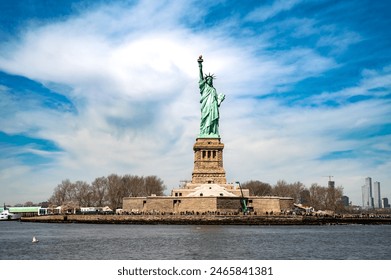 Lady Liberty lights the way! Capture the iconic symbol of freedom, her torch held high against a clear blue sky. Ideal for travel and history content.  - Powered by Shutterstock