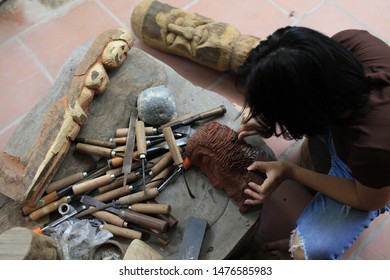 A Lady Is Making Details For A Wood Statue