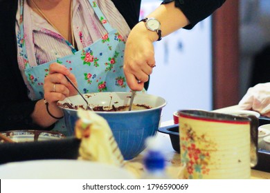 Lady Mixing A Chocolate Pudding In A Blue Mixing Bowl