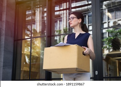 A Lady Officer Or Businesswoman Leaving Or Resign Or Dismiss From Job, Woman Carry Personal Box Walking Out From Office