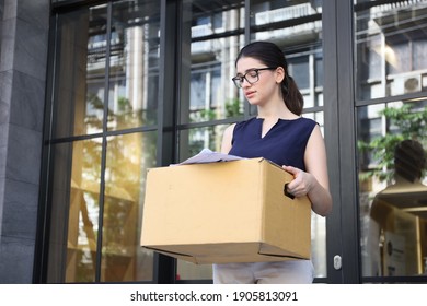 A Lady Officer Or Businesswoman Leaving Or Resign Or Dismiss From Job, Woman Carry Personal Box Walk Out From Office