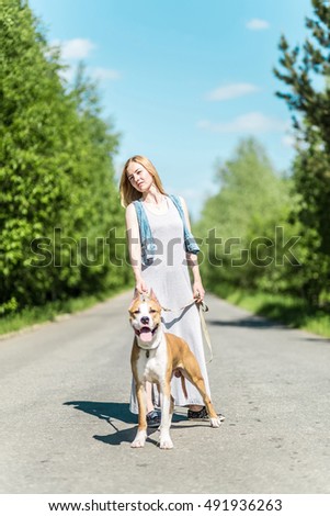 Similar – Attractive smiling blond woman with her two dogs