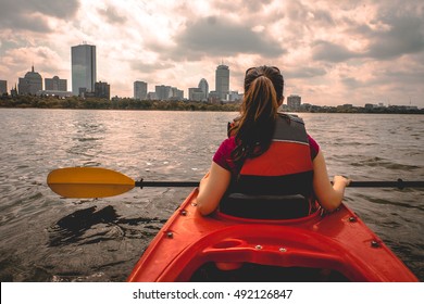 Lady paddling the kayak in Boston