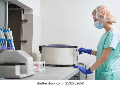 Lady Prepearing For Medical Research With Centrifuge In Hospital