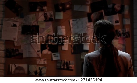 Lady private agent looking at crime investigation board, chasing serial killer