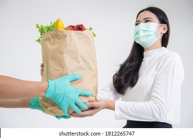 Lady Recieving Food  Ingredients From Food Delivery Driver  Man With Surgical Mask