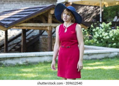Lady in red wearing blue retro hat
