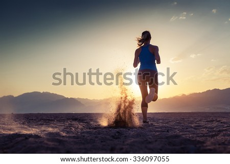 Lady running in the desert at sunset