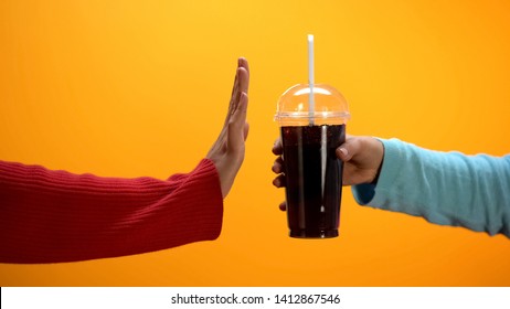 Lady Showing Stop Gesture To Soft Drink On Bright Background, Sugar Overweight