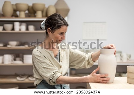 Similar – Beautiful ceramist owner looking to the camera while smiling