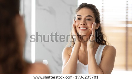 Lady Touching Face With Perfect Smooth Skin Standing In Bathroom