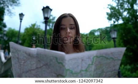 Lady tourist using map for navigation, lost in unfamiliar place, sightseeing