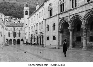 A Lady Tourist Walking Past The Rectors Palace In Dubrovnik.