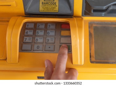 Lady Using ATM Machine To Withdraw Her Money. Close-up Of Hand Entering PIN/pass Code On ATM/bank Machine Keypad. Finger About To Press A Pin Code On A Pad. Security Code On Automated Teller Machine.