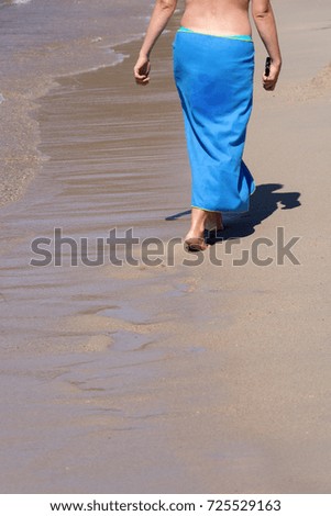 lady walking on a sandy beach
