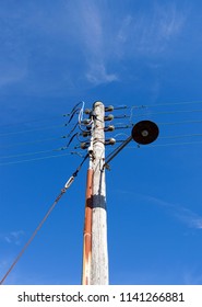 Laesoe / Denmark: Old Wooden Power Pole With Simple Swing Arm Jib Lamp At The Flarumvej In Vesteroe Havn