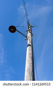 Laesoe / Denmark: Old Wooden Power Pole With Simple Swing Arm Jib Lamp At The Flarumvej In Vesteroe Havn