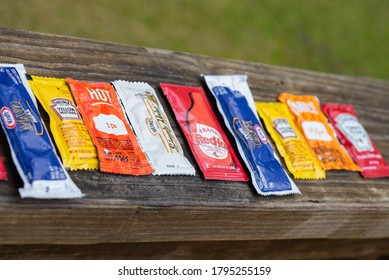 LAFAYETTE, L.A. / USA -  MARCH 3, 2020: A Variety Of Condiment Packets Placed In A Row, Focusing In On The Orange Packet Of Taco Bell Hot Sauce.