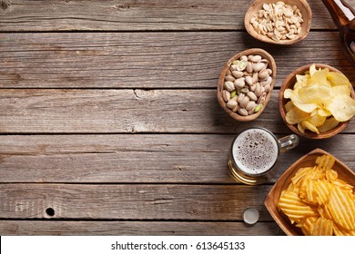 Lager Beer Mug And Snacks On Wooden Table. Nuts, Chips. Top View With Copyspace