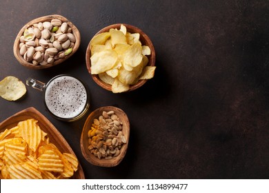 Lager Beer And Snacks On Stone Table. Nuts, Chips. Top View With Copyspace