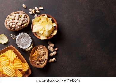 Lager Beer And Snacks On Stone Table. Nuts, Chips. Top View With Copyspace