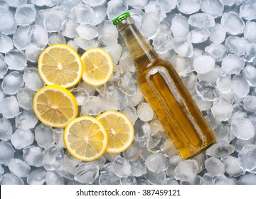 lager bottle with lemon slices in the ice. top view