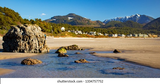 Lagoon At Cannon Beach, Oregon With Snow And Forrest Mountains In The Background